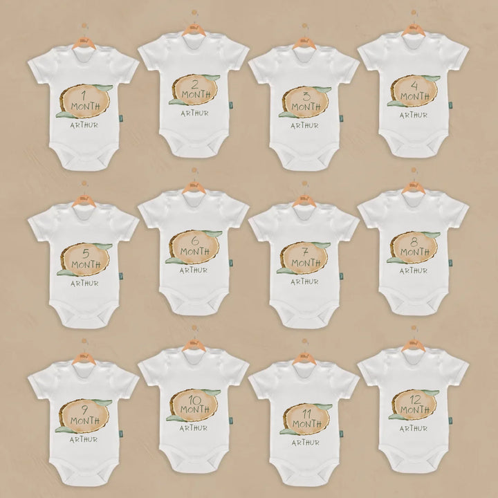 12-piece baby milestone romper set featuring woodland animal illustrations and personalized name for capturing growth.