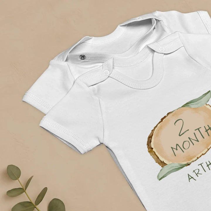 Forest Touch Design baby romper set showcasing '2 Months' milestone with personalized name feature.