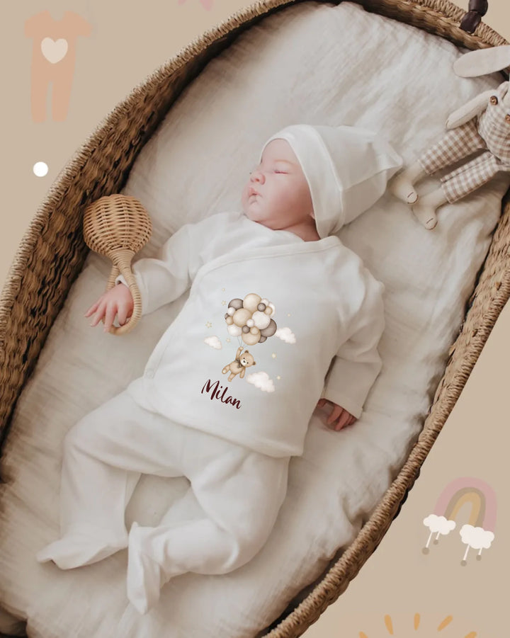Baby in personalized organic cotton outfit, sleeping peacefully with cute lion design.