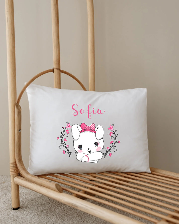 Personalisable decorative pillow with cute bunny illustration and the name Sofia in pink.
