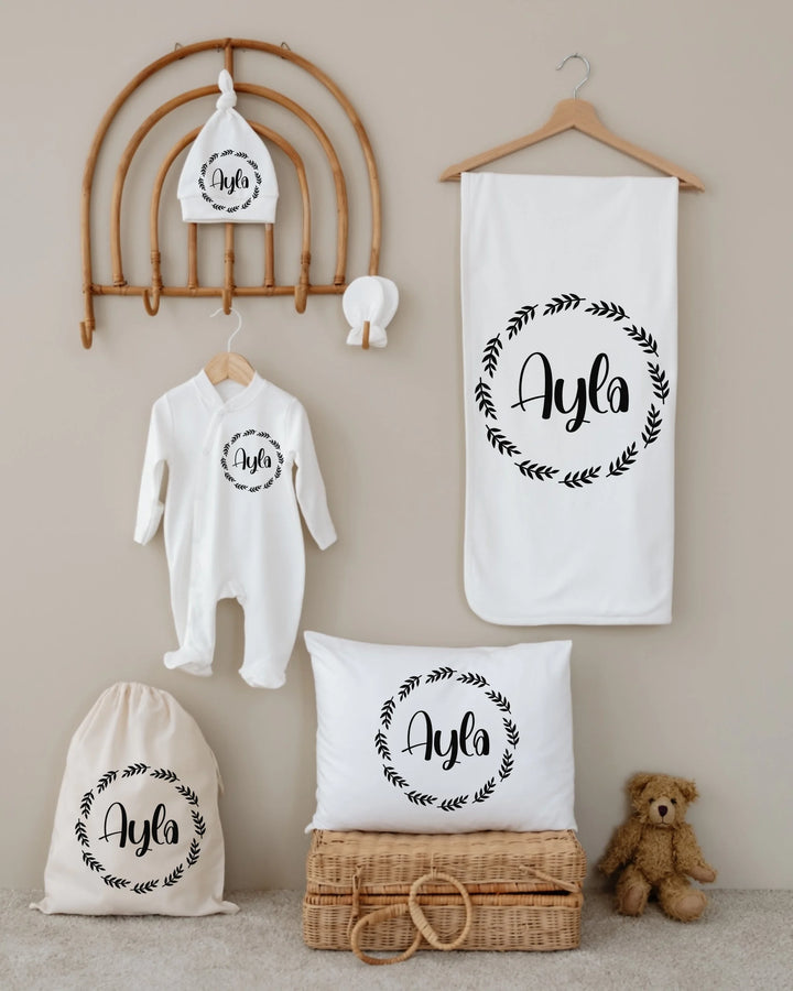 6-piece personalized newborn gift set featuring name Ayla with minimalist design and neutral colors.