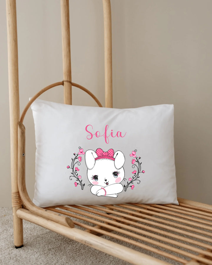 Personalized pillow featuring a cute bunny with pink bow and the name Sofia, designed for nursery decor.
