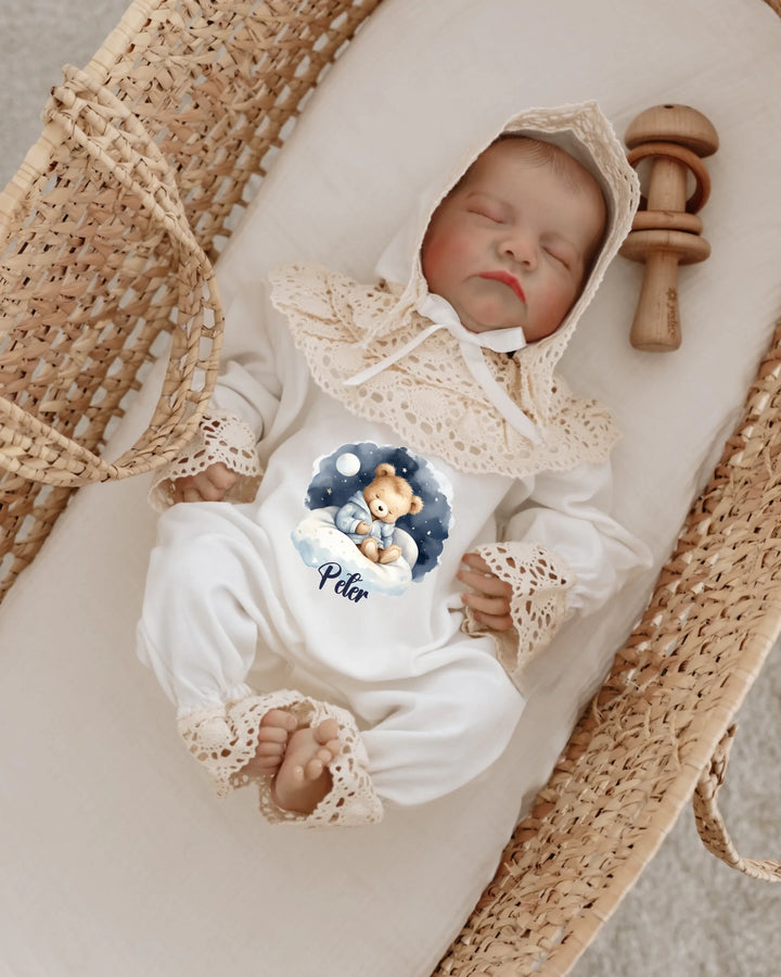 Newborn in teddy bear personalized jumpsuit, peacefully sleeping in a cozy basket with soft colors and lace details.