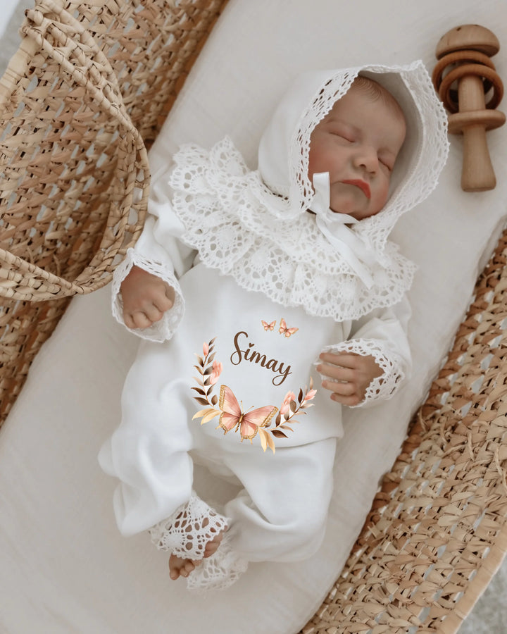 Gepersonaliseerd kanten babypakje met vlinderkrans voor meisjes, ideaal als geboortepakje of kraamcadeau.