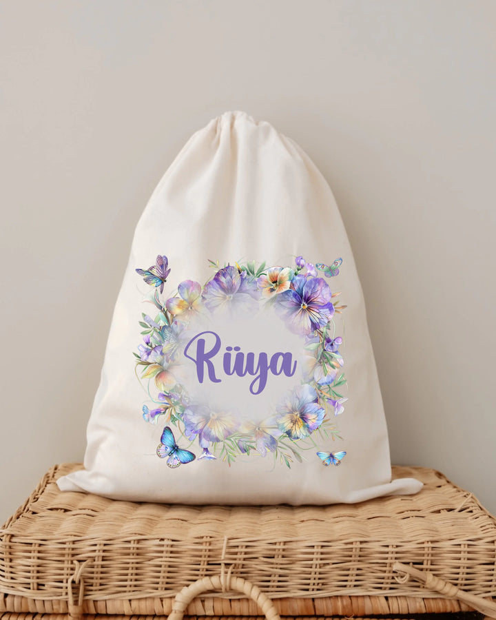 Personalisierbare Baumwolltasche mit Blumenkranz und dem Namen Rüya in lila, perfekt für Babygeschenke.