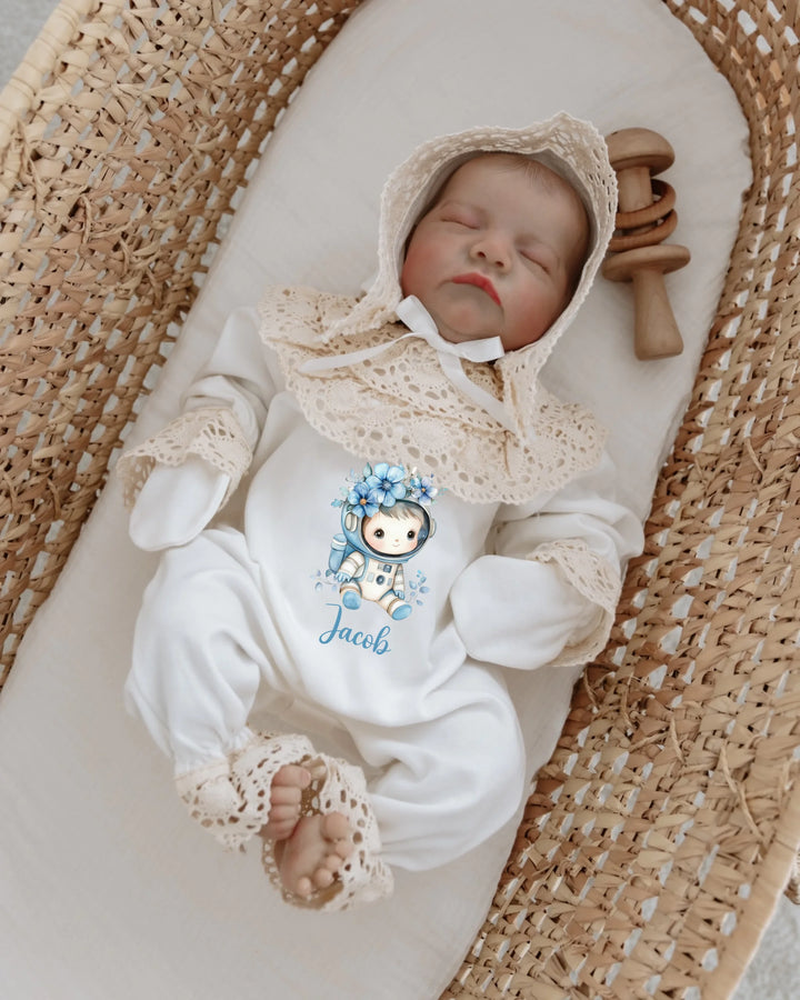 Newborn astronaut outfit with lace details, personalized with the name Jacob, resting in a cozy basket.