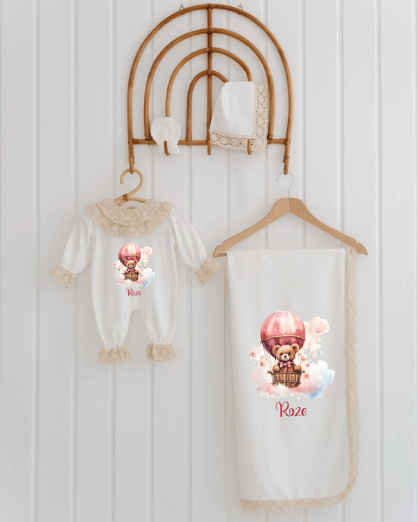 4-piece newborn set for girls featuring teddy bear and hot air balloon design, personalized with name in soft pinks.