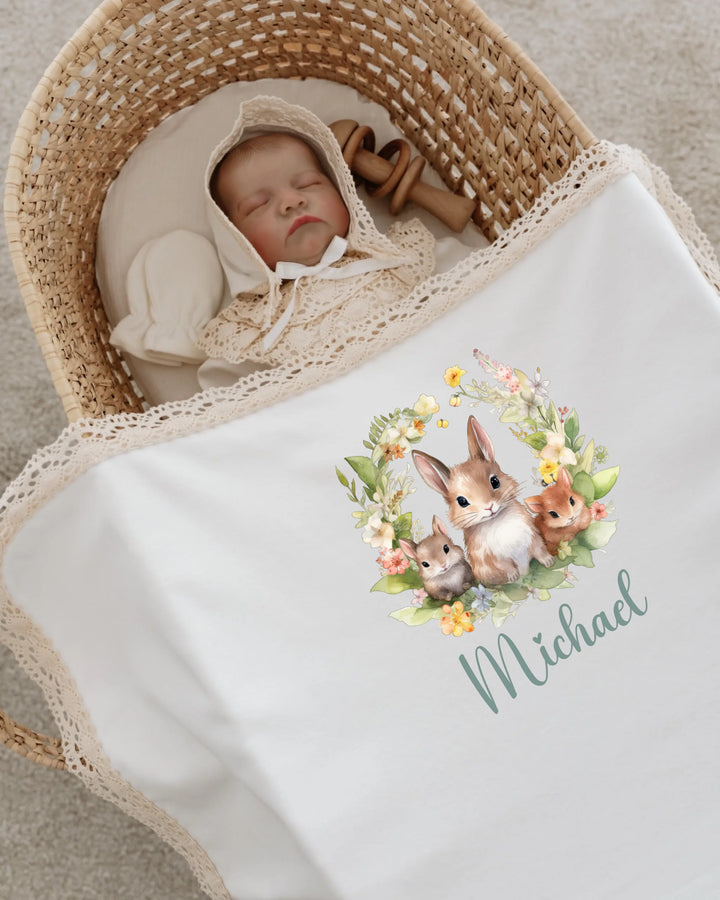 Newborn baby named Michael asleep in a cozy basket with a floral animal blanket.