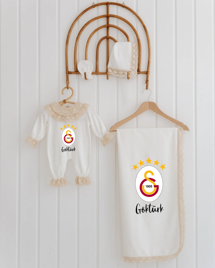 Galatasaray newborn set featuring romper, blanket, and accessories with logo and lace details for girls.