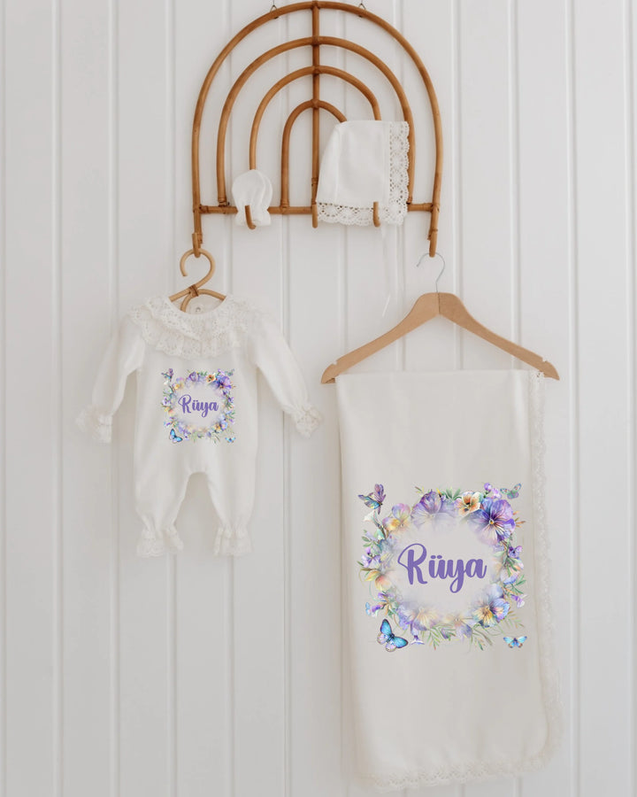 Blooming newborn clothing set with personalized name, featuring a floral romper and blanket, perfect for baby girls.
