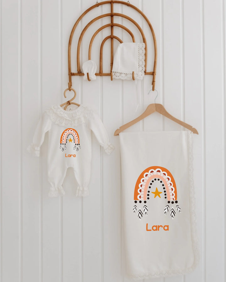 Boho newborn girl clothing set with personalized romper and blanket featuring rainbow design and lace details.